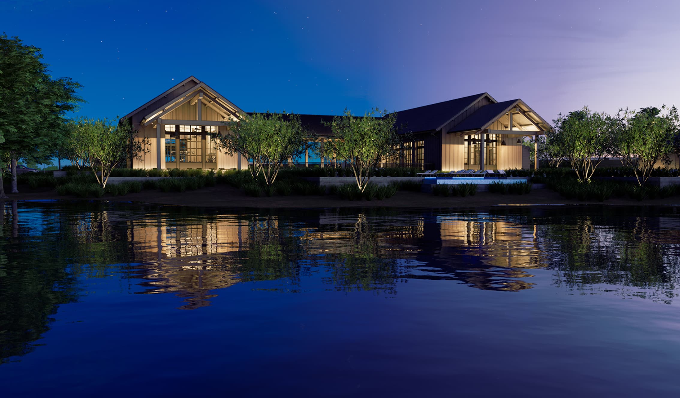 A modern stone building with large windows is surrounded by landscaped greenery at dusk, showcasing the appeal of new homes in North Texas, with people and a parked car visible in front.