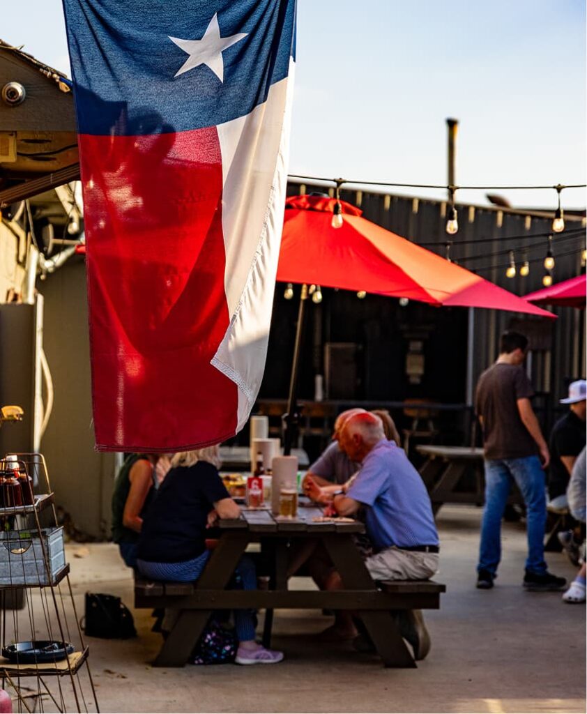 A group enjoying drinks at an outdoor patio.